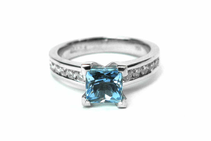 Aquamarine four claw set ring with channel set diamonds