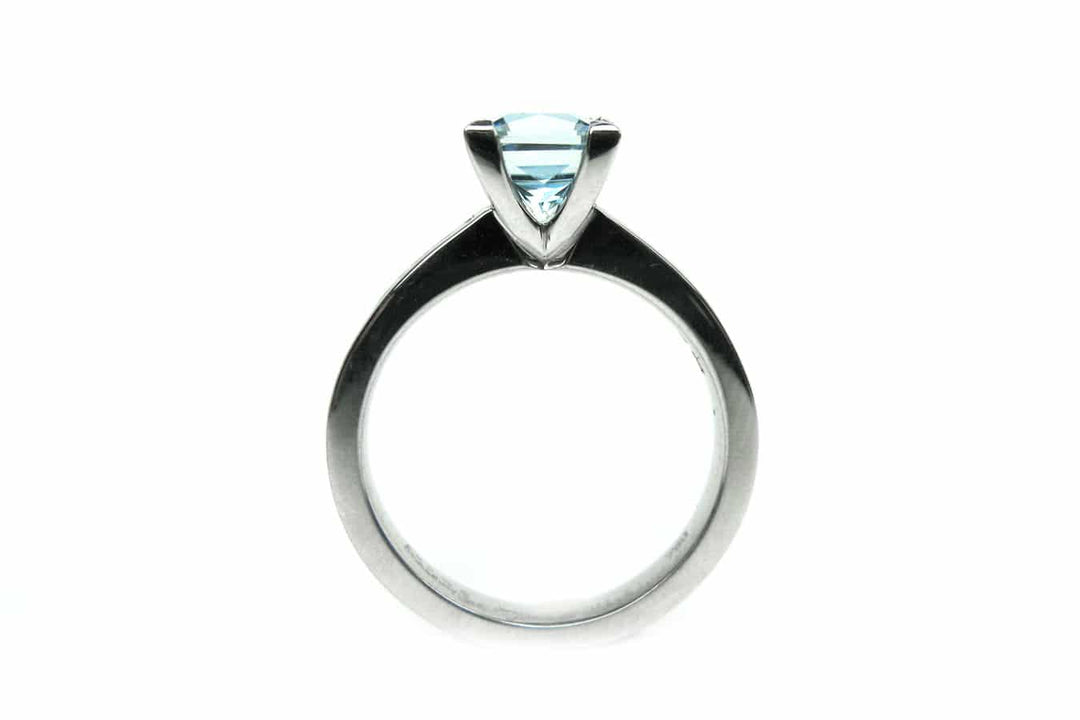 Aquamarine four claw set ring with channel set diamonds