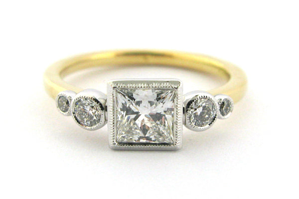 Two tone bezel set princess and round brilliant cut diamond ring