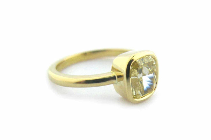 Bezel set yellow cushion cut diamond ring
