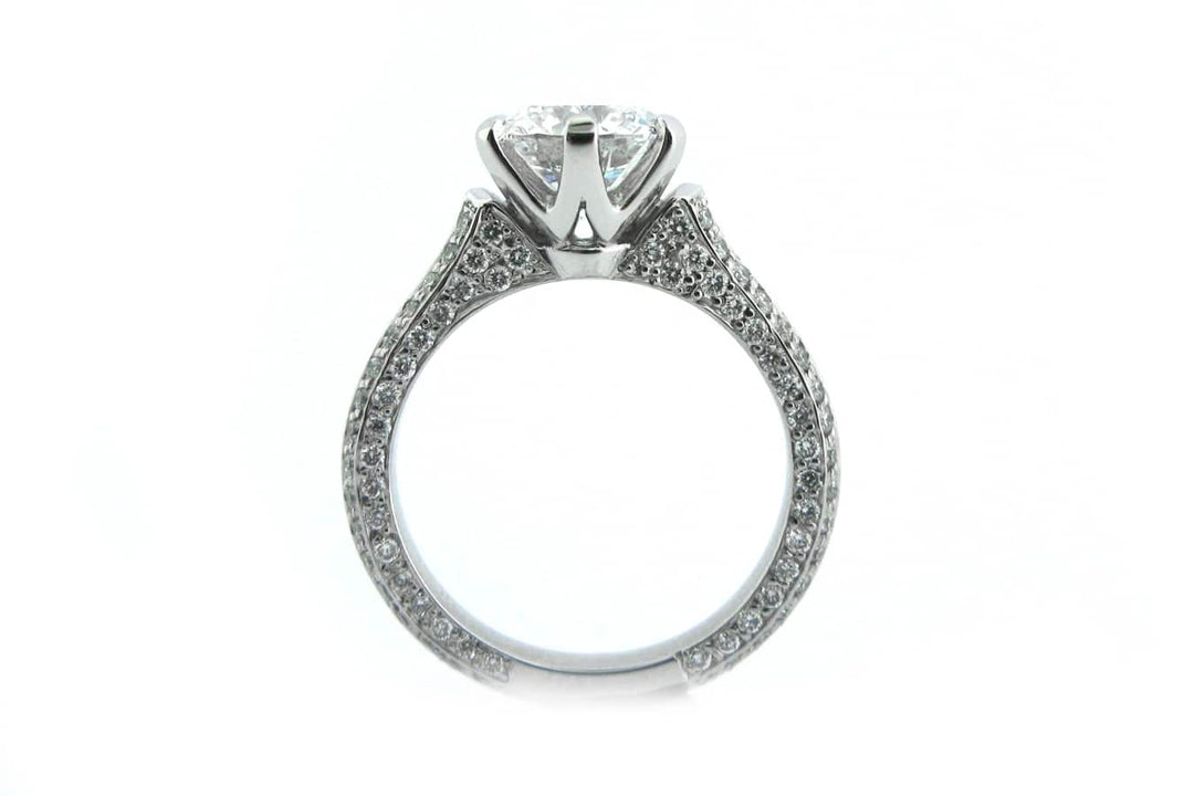 Claw set round brilliant cut ring with knife edge band