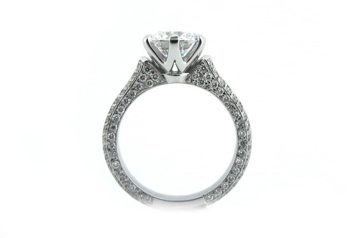 Claw set round brilliant cut ring with knife edge band