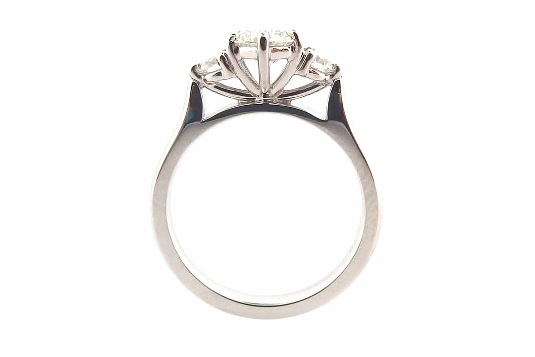 Claw set round brilliant cut three stone ring