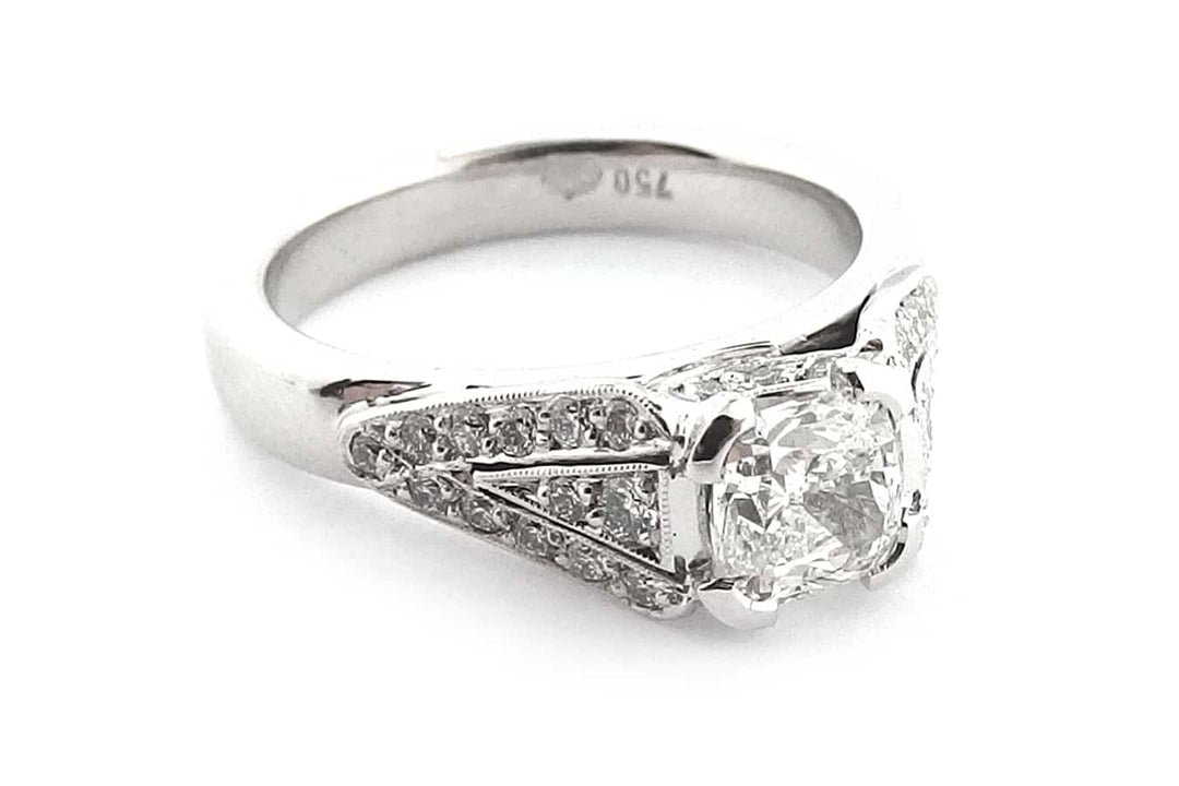 Cushion cut diamond with bead set diamonds and a milgrain edge