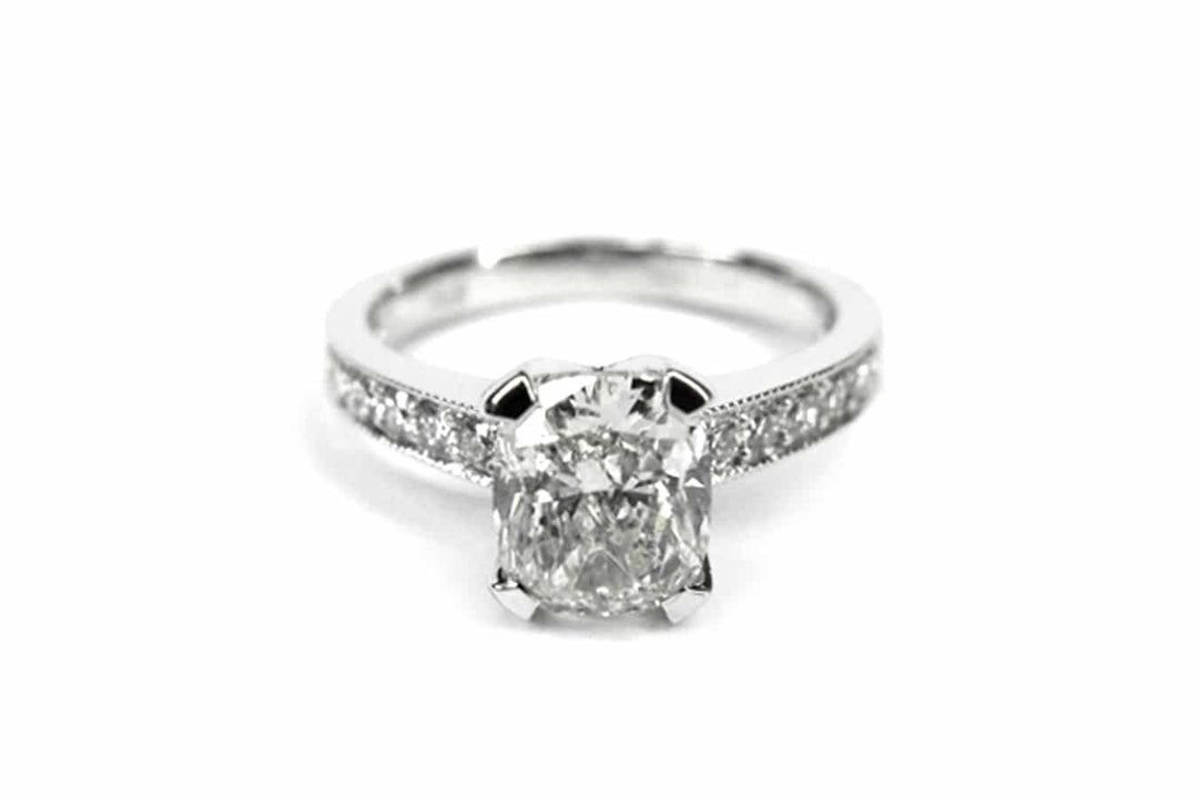 Cushion cut ring with bead set diamonds