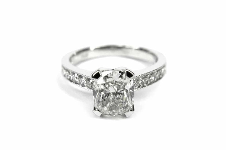 Cushion cut ring with bead set diamonds