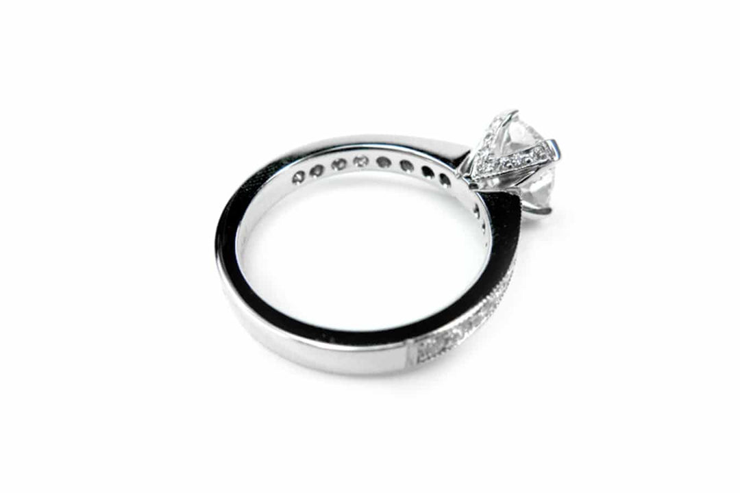 Cushion cut ring with bead set diamonds