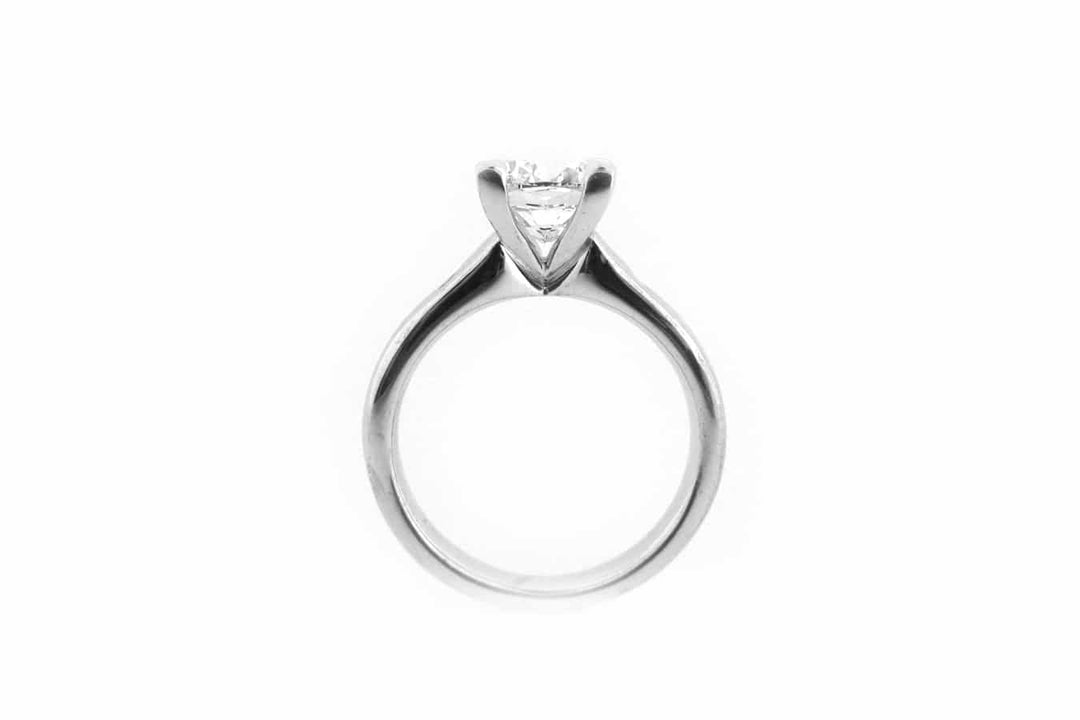 Cushion cut ring with two hammer set pink diamonds