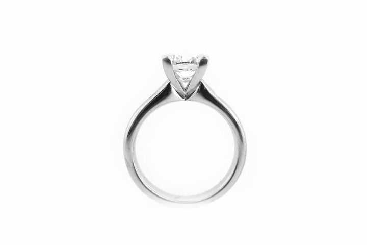 Cushion cut ring with two hammer set pink diamonds