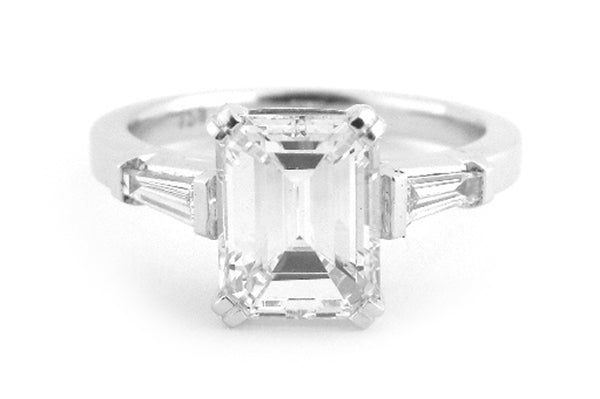 Emerald cut diamond with a double claw and tapered baguettes