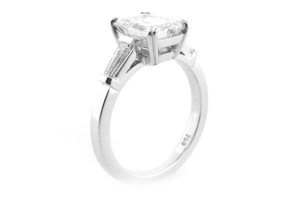 Emerald cut diamond with a double claw and tapered baguettes
