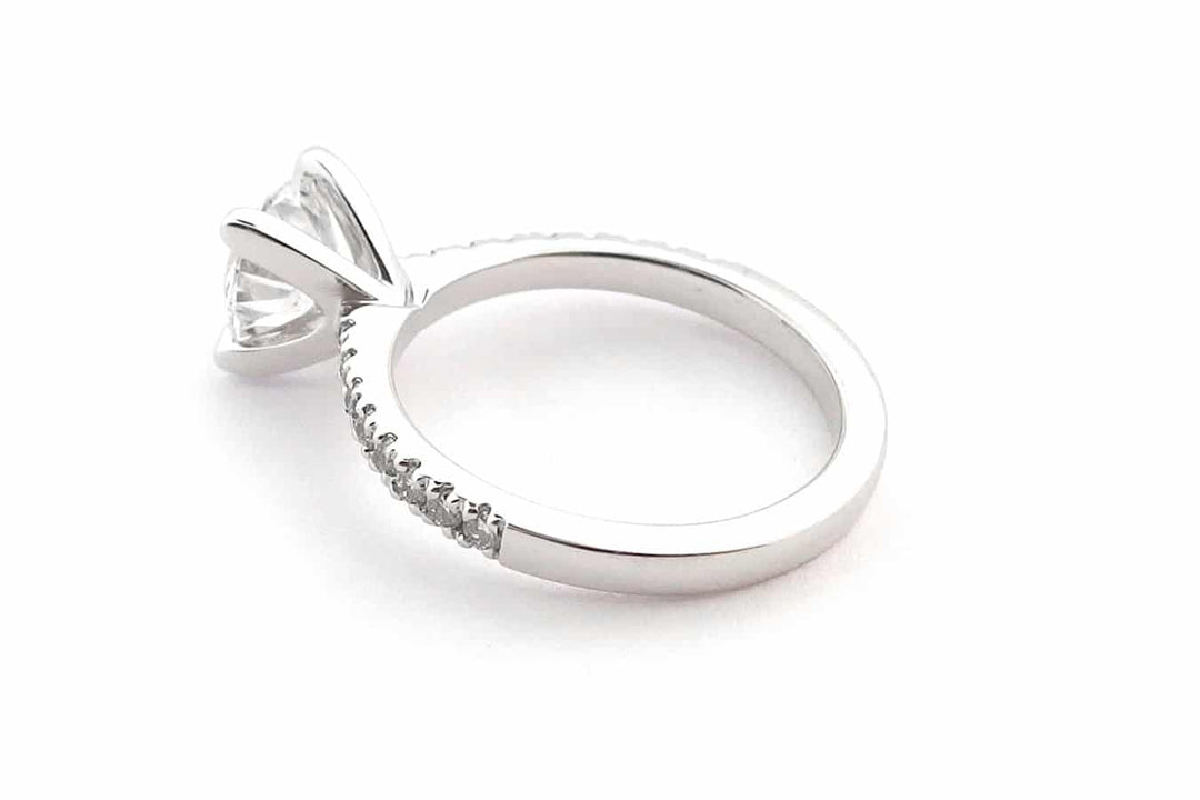 Four claw round brilliant cut ring with claw set diamond band