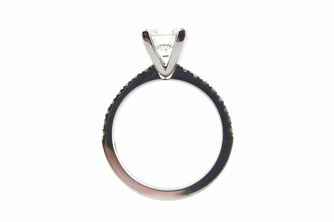 Four claw round brilliant cut ring with claw set diamond band