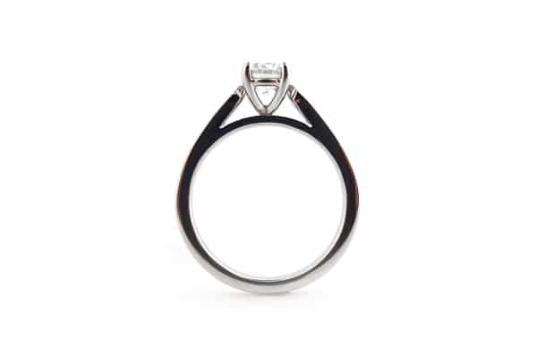 Four claw set round brilliant cut diamond ring with graduated bead set diamonds