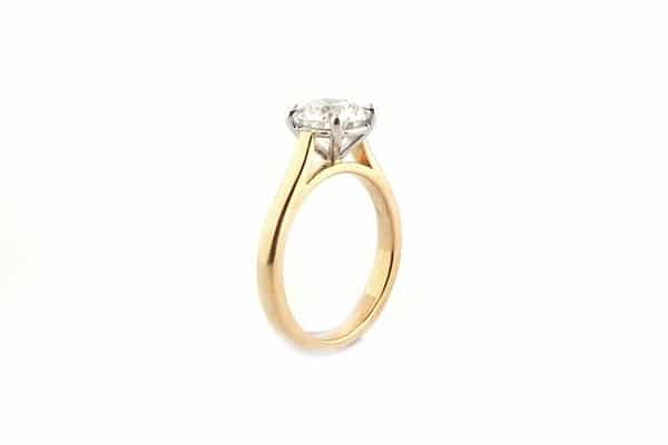 Four claw two tone round brilliant cut ring