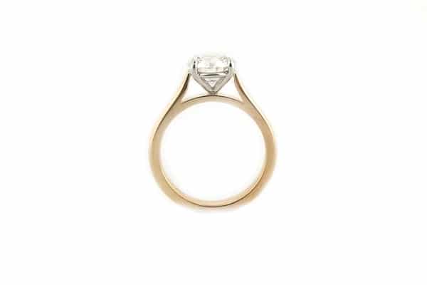 Four claw two tone round brilliant cut ring