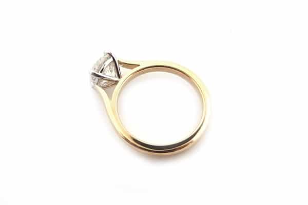 Four claw two tone round brilliant cut ring
