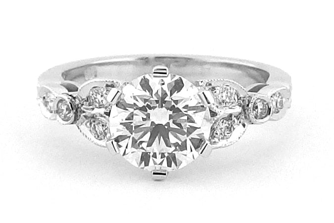Ornate six claw round brilliant cut ring