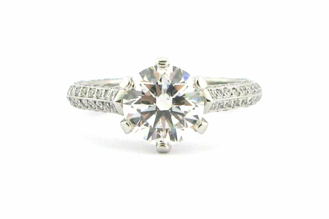 Claw set round brilliant cut ring with knife edge band