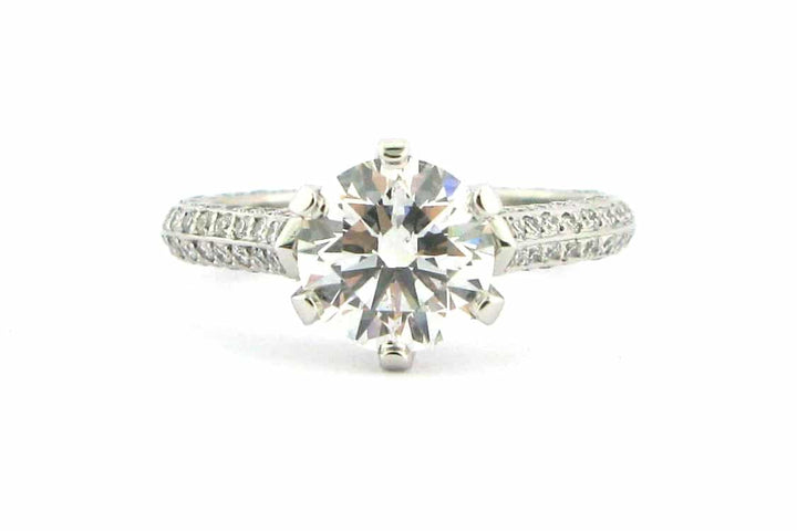 Claw set round brilliant cut ring with knife edge band