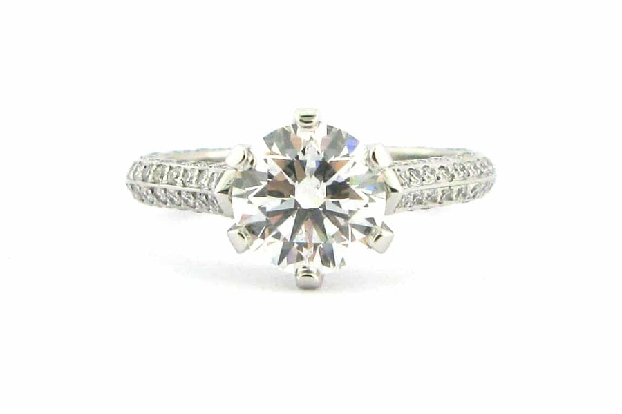 Claw set round brilliant cut ring with knife edge band