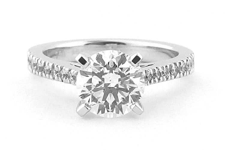 Four claw round brilliant cut ring with claw set band