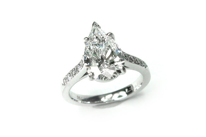 Pear shape diamond ring with bead set diamonds