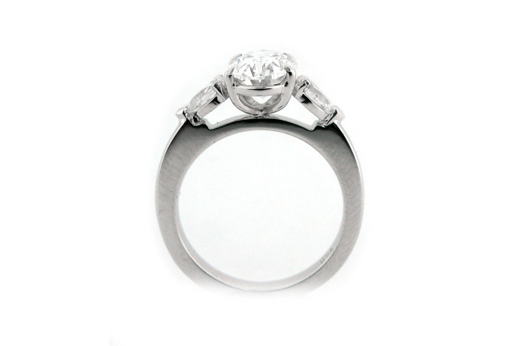 Oval and pear shape diamond three stone ring