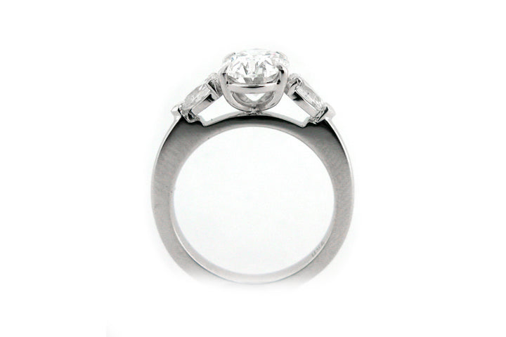 Oval and pear shape diamond three stone ring