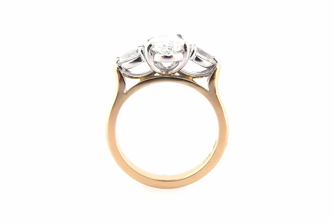 Oval diamond ring with pear shape side stones