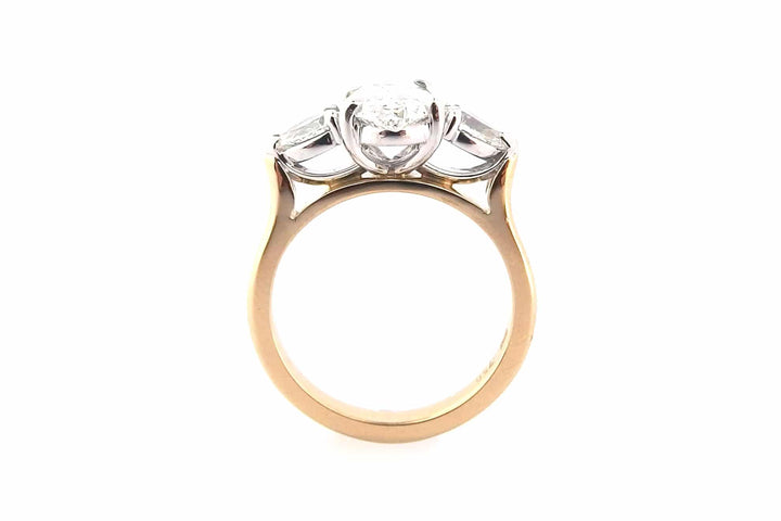 Oval diamond ring with pear shape side stones