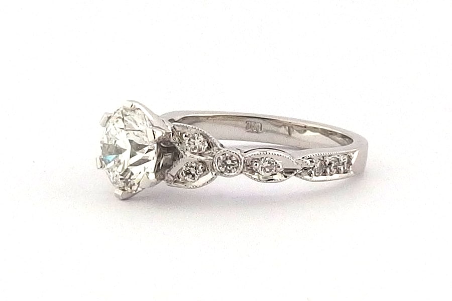 Ornate six claw round brilliant cut ring