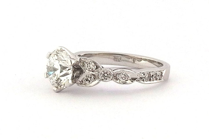 Ornate six claw round brilliant cut ring