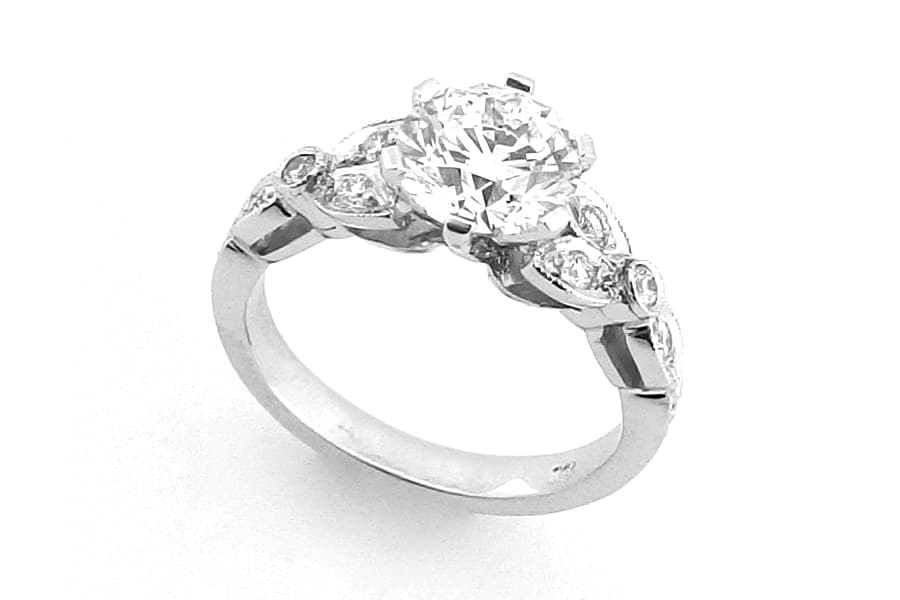 Ornate six claw round brilliant cut ring