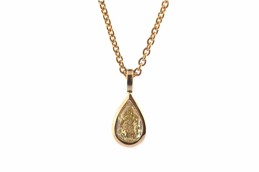 Yellow pear shape diamond pendant, bezel set.