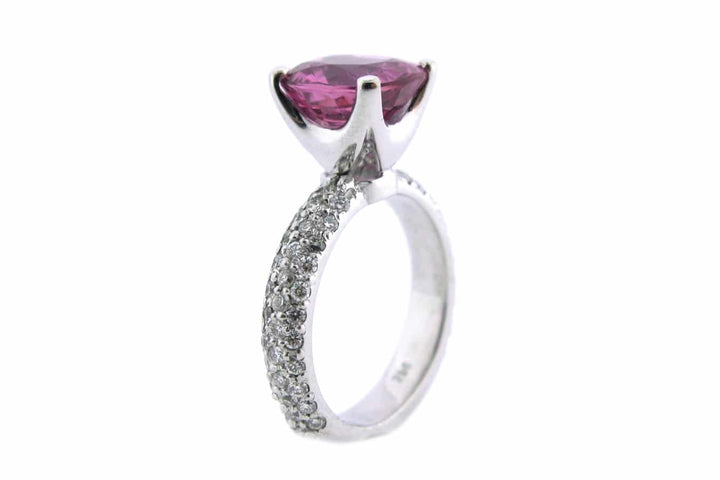 Pink cushion cut sapphire with a diamond set band