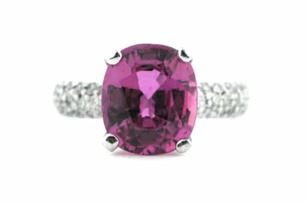 Pink cushion cut sapphire with a diamond set band