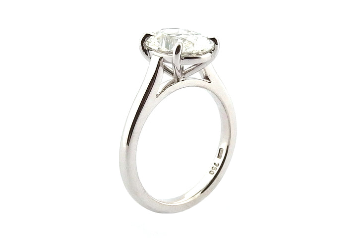Platinum oval diamond ring with a fine four claw setting