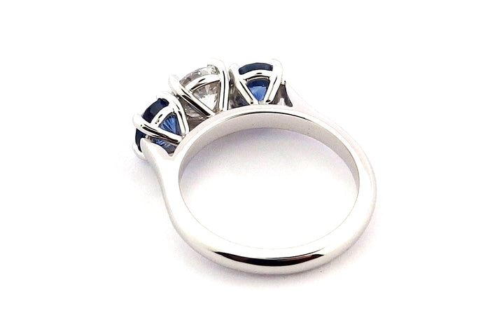 Platinum sapphire and diamond claw set three stone ring