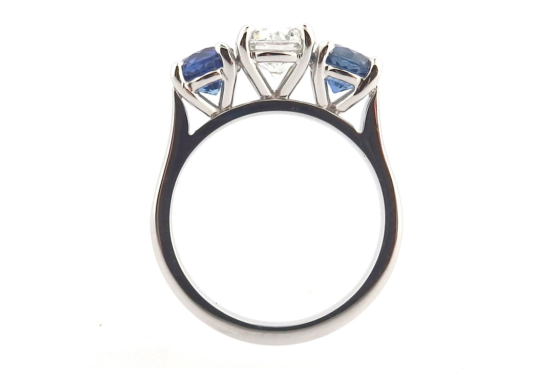 Platinum sapphire and diamond claw set three stone ring