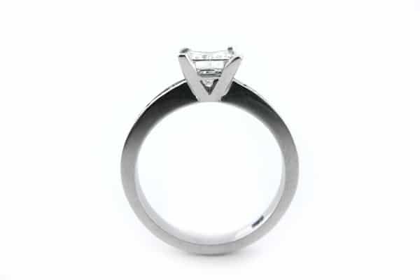 Princess cut diamond ring with channel set diamonds in the band