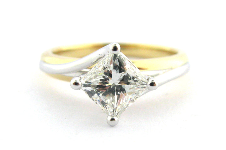 Two tone princess cut diamond ring set on the diagonal and a twisted band