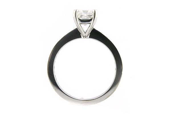 Radiant cut diamond ring with a bead set band