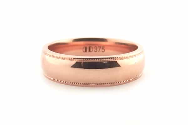 Rose gold men's wedding band with a milgrain edge