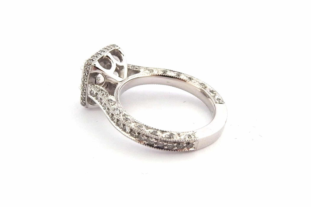 Round brilliant cut diamond ring set with double claws and a halo of diamonds