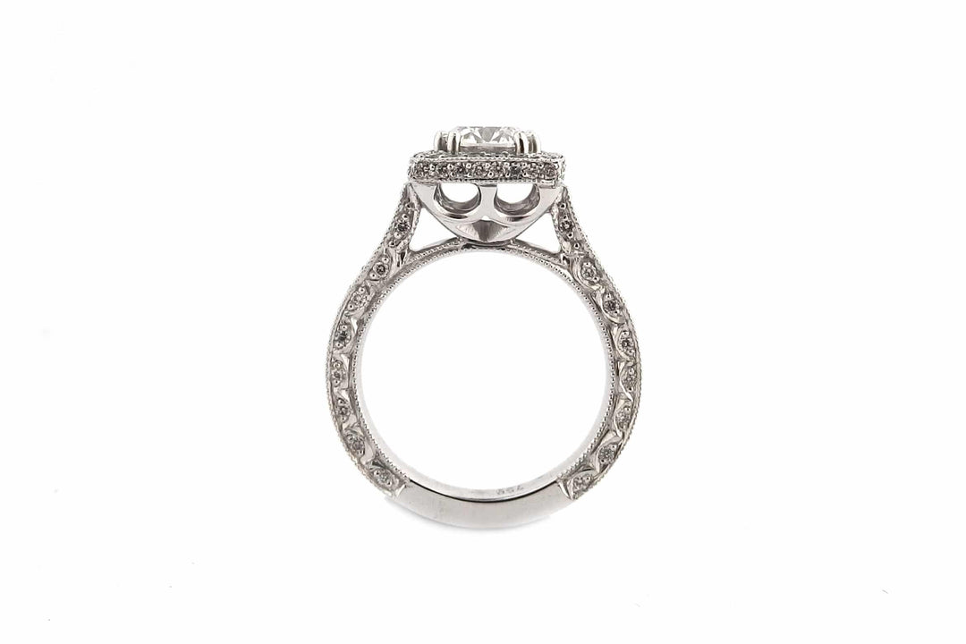 Round brilliant cut diamond ring set with double claws and a halo of diamonds