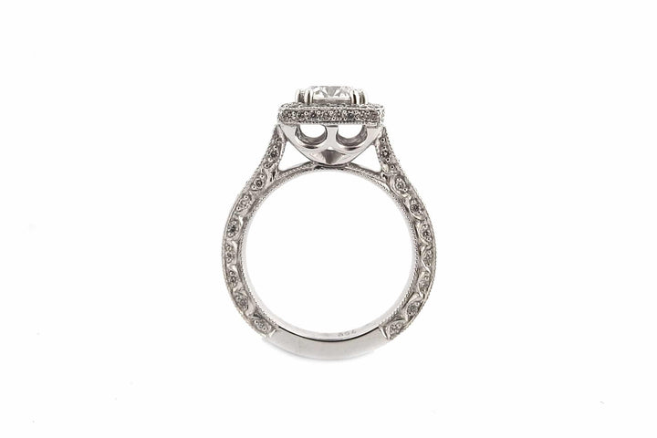 Round brilliant cut diamond ring set with double claws and a halo of diamonds