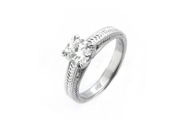 Round brilliant cut diamond ring with engraving on the band