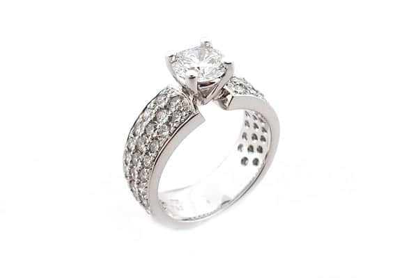 Round brilliant cut ring with three rows of diamonds