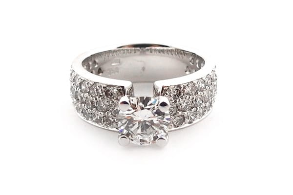 Round brilliant cut ring with three rows of diamonds